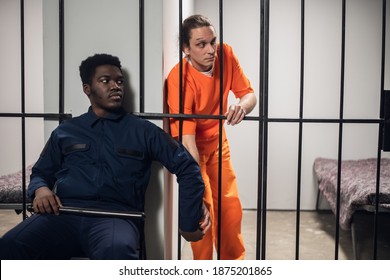 A Prison Guard Passes A Prisoner A Cell Phone Through The Bars Illegal Contraband