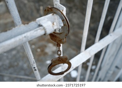                             Prison Handcuffs hang on Jail 