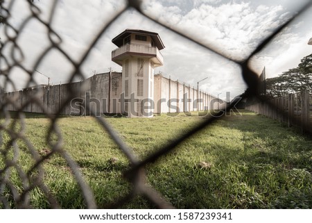 Prison with iron fences.Prison or jail is a building where people are forced to live if their freedom has been taken away.Prison is the building use for punishment prisoner.