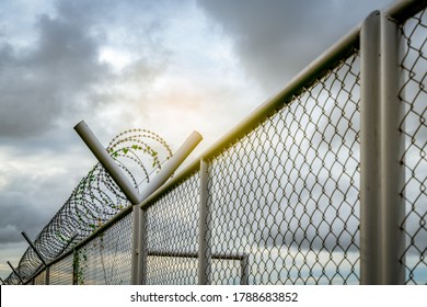 Prison security fence. Barbed wire security fence. Razor wire jail fence. Barrier border. Boundary security wall. Prison for arrest criminals or terrorists. Private area. Military zone concept. 