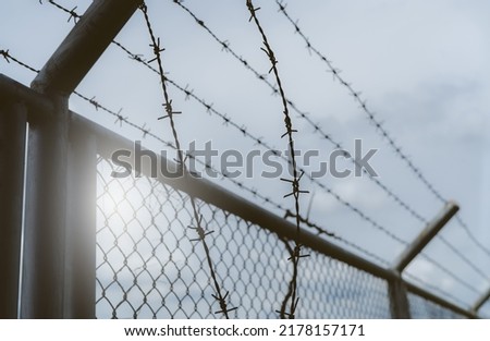Prison security fence. Border fence. Barbed wire security fence. Razor wire jail fence. Boundary security wall. Prison for arrest of criminals or terrorists. Private area. Military zone concept. 