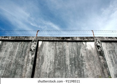 The Prison Walls With High Walls And Barbed Iron Wire