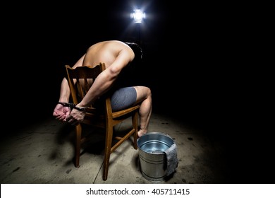 Prisoner being punished with cruel interrogation technique of waterboarding.  The man is restrained and tortured.
