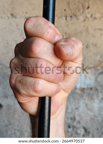 prisoner looking out of the window of a prison cell