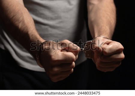 Prisoner male hands criminal with handcuffs.
