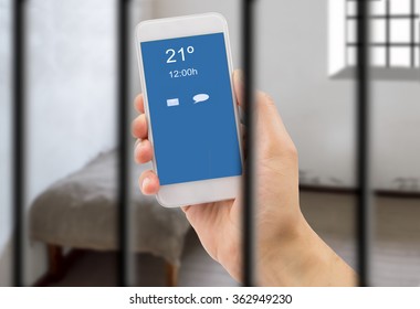 Prisoner Man With A Smart Phone Inside The Jail