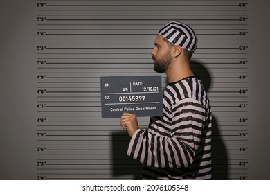 Prisoner With Mugshot Letter Board At Police Department