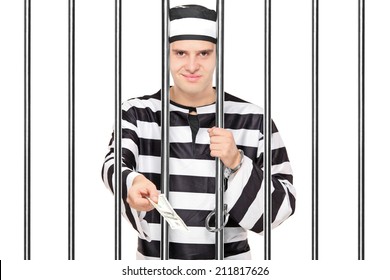 Prisoner Offering Bribe To Someone Behind Bars Isolated On White Background