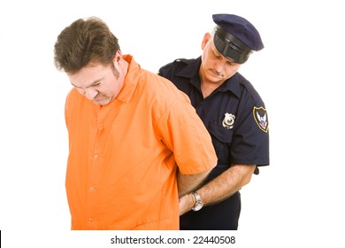 Prisoner In Orange Jump Suit Being Handcuffed By Police Officer.  Isolated On White.