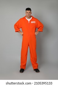 Prisoner In Orange Jumpsuit On Grey Background