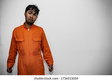 Prisoner in orange robe concept,Portrait of asian handsome man in Prison uniforms,Bandit has a lot of muscle, - Shutterstock ID 1736515034