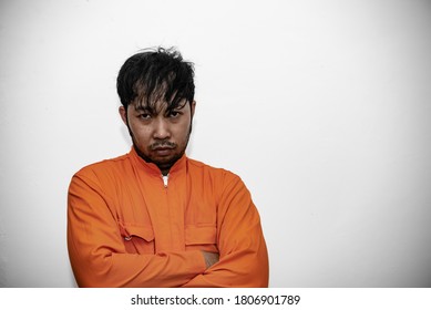 Prisoner in orange robe concept,Portrait of asian handsome man in Prison uniforms,Bandit has a lot of muscle, - Shutterstock ID 1806901789