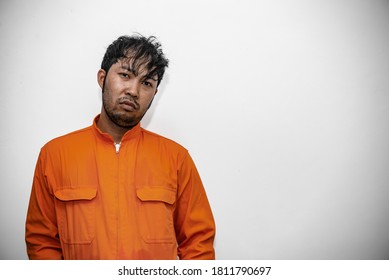 Prisoner in orange robe concept,Portrait of asian handsome man in Prison uniforms,Bandit has a lot of muscle, - Shutterstock ID 1811790697