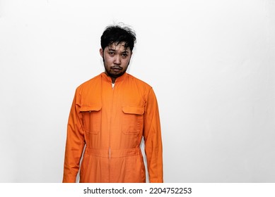 Prisoner in orange robe concept,Portrait of asian handsome man in Prison uniforms,Bandit has a lot of muscle,