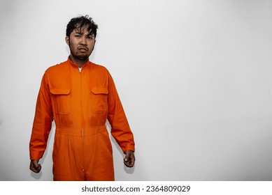 Prisoner in orange robe concept,Portrait of asian handsome man in Prison uniforms,Bandit has a lot of muscle, - Shutterstock ID 2364809029