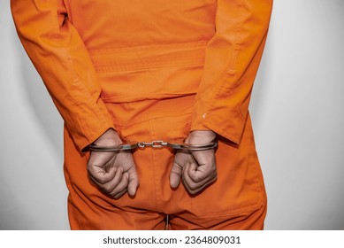 Prisoner in orange robe concept,Portrait of asian handsome man in Prison uniforms,Bandit has a lot of muscle, - Shutterstock ID 2364809031