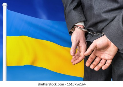 Prisons And Corruption In Ukraine. Businessman With Handcuffs On National Flag Background.