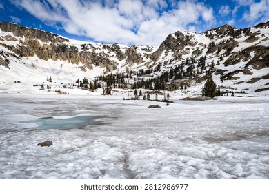Pristine alpine Lake Solitude surrounded by towering Teton peaks in a sweeping panoramic view