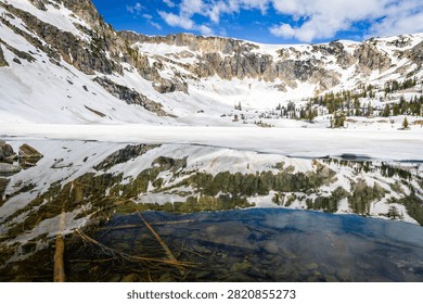 Pristine alpine Lake Solitude surrounded by towering Teton peaks in a sweeping panoramic view
