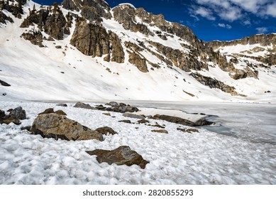 Pristine alpine Lake Solitude surrounded by towering Teton peaks in a sweeping panoramic view