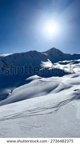 Pristine arctic snowscape under blue sky, untouched wintry wilderness, embodying Chilblain Days frosted whispers and Solstice serenity