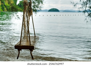 Pristine beach with turquoise water and rope swing, green foliage. High quality photo - Powered by Shutterstock