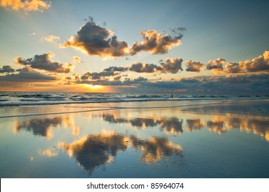 pristine florida atlantic ocean beach at sunrise, with actual reflections in water