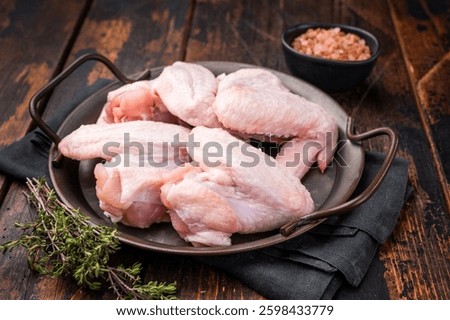 Pristine raw poultry wings, waiting to be seasoned and transformed into mouthwatering dishes for any occasion. wooden background. top view.