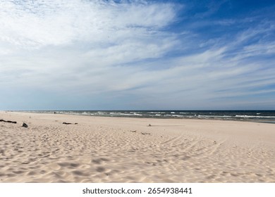 Pristine Sandy Beach with Blue Sky and Ocean Waves