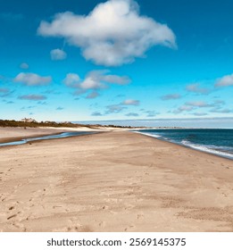 Pristine Sandy Beach with Ocean Waves and Blue Sky