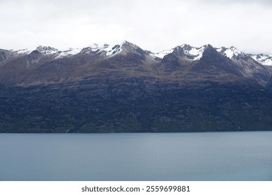 Pristine Snowy Mountain Peaks Under a Clear Blue Sky - Powered by Shutterstock