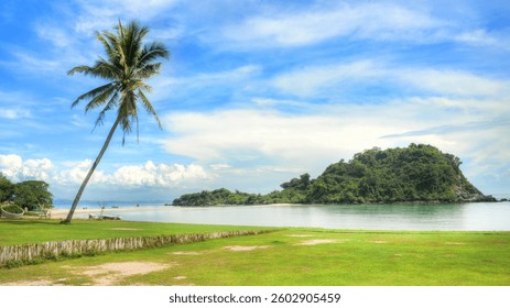 Pristine summer beach featuring a lone palm tree and a serene island surrounded by calm turquoise waters under a clear blue sky.