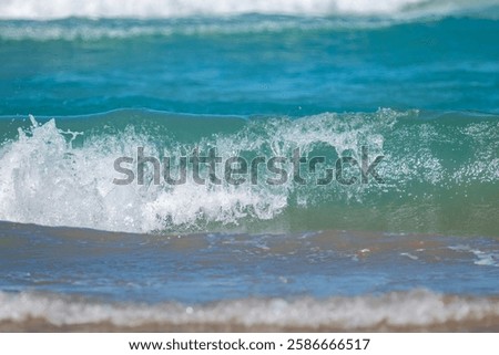 Pristine waves of turquoise waters in the Gulf of Mexico crash along the shores of South Padre Island in south Texas.