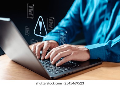 privacy, attack, hacking, programmer, technology, danger, access, virtual, criminal, safety. A man is typing on a laptop with a warning sign on the screen, suggests that something is wrong.