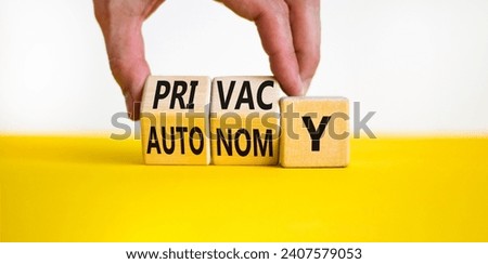 Privacy or autonomy symbol. Concept word Privacy or Autonomy on wooden cubes. Beautiful yellow table white background. Businessman hand. Business privacy or autonomy concept. Copy space.