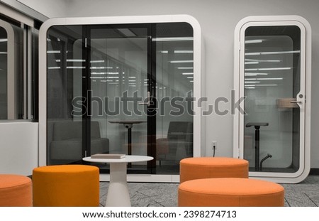 Privacy booth furniture sitting empty in an office environment. Quiet focus room space for meetings and avoiding noisy distractions.
