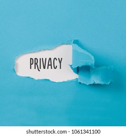 Privacy, message on torn blue paper revealing secret behind ripped opening. - Shutterstock ID 1061341100