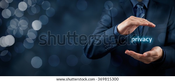 Privacy policy concept. Businessman with
protective gesture and text privacy in hands. Wide banner
composition with bokeh in
background.
