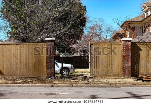 Privancy fence repair -\
Truck parked inside yard where a wreck has occured and fence is\
being rebuilt.jpg
