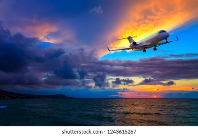 Private Business Jet Plane Flying Over The Sea At Sunset,