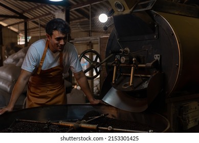 Private Business Owner Controlling Coffee Roasting Process. Coffee Roaster Working On Roasting Equipment.