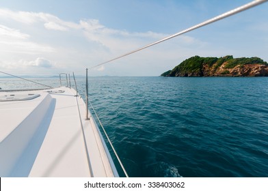 Private Catamaran Boat Sailing To The Island Ahead. Luxury Lifestyle. Traveling On A Yacht