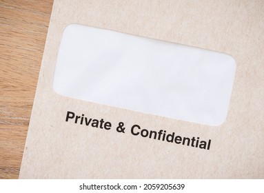 Private And Confidential Business Envelope On A Desk. Window Envelope For Confidential Documents, UK