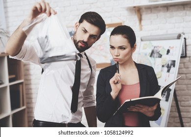 Private Detective Agency. Man With Holster And Woman Are Looking At Gun Clue And Taking Notes.