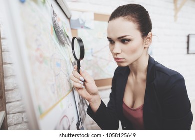 Private Detective Agency. Woman In Jacket Is Looking At Clue Map With Magnifying Glass In Office.