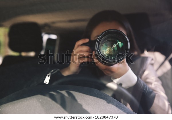 Private detective\
with camera spying from\
car