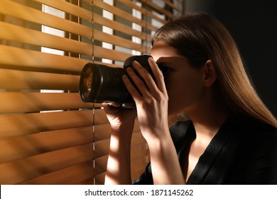 Private Detective With Camera Spying Near Window Indoors