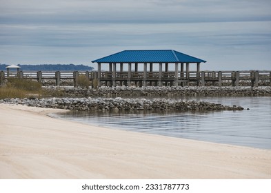 A private dock with rock jetties on the beach on the Bay of Biloxi in Ocean Springs, Mississippi. - Powered by Shutterstock
