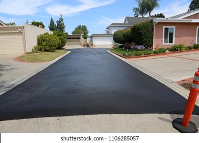 Private drive way, street rehabilitation and slurry seal project finished with crews expertly applying the slurry seal. Re-surfaced Cul-de-sac shown with unidentifiable crew working


 - Shutterstock ID 1106285057