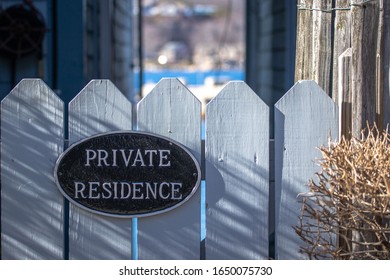 A Private Entrance Sign With A Glimpse Of The Ocean In The Back Ground